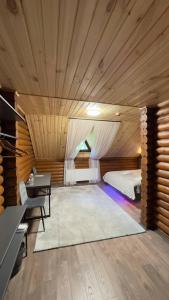 a bedroom with a bed and a desk in a room at Готель Кумир in Rivne