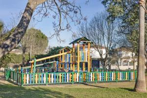 a playground in a park next to a tree at Rural El Santiscal in Arcos de la Frontera