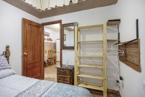 a bedroom with a bed and a book shelf at Rural El Santiscal in Arcos de la Frontera +29 photos