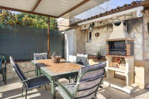 a patio with a table and an outdoor oven at Rural El Santiscal in Arcos de la Frontera