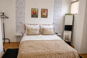 a bedroom with a bed and two pictures on the wall at Green Paradise in Vrnjačka Banja