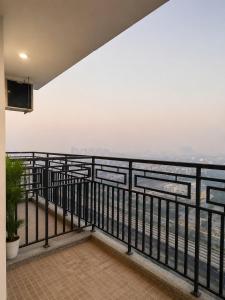 a balcony with a view of the water at The Sky cabin in Greater Noida