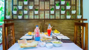 a table with food and drinks on it at Sansevieria Homestay in Sigiriya