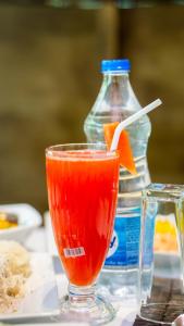 a drink sitting on a table with a bottle of water at Sansevieria Homestay in Sigiriya +35 photos