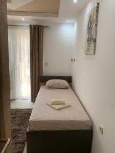a bedroom with a bed in a room with a window at Eliksir 2 in Gornja Trepča