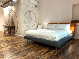 a bedroom with a bed and a desk in it at Residenza Basiglio in Ceva +3 photos