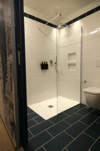 a bathroom with a glass shower with a toilet at Residenza Basiglio in Ceva