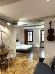 a bedroom with a bed and a couch and a table at Residenza Basiglio in Ceva