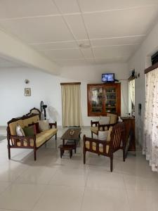a living room with two couches and a table at Emerald canopy retreat in Kandy