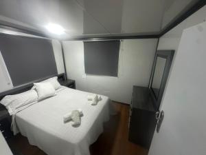 a bedroom with a bed with two towels on it at La Casita in Seville +2 photos