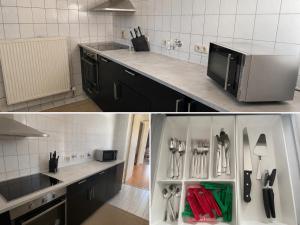 a kitchen with black cabinets and a refrigerator with utensils at Cool Apart Chemnitz in Chemnitz