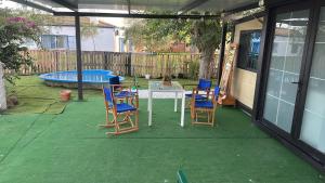 a patio with chairs and a table and a pool at La Casita in Seville