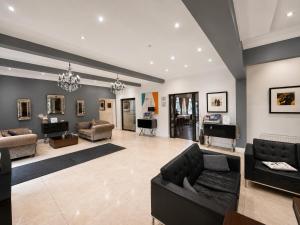 a large living room with couches and a piano at OYO The Baltimore Hotel in Middlesbrough