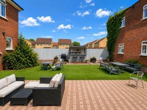 a backyard with a couch and a table and chairs at OYO The Baltimore Hotel in Middlesbrough