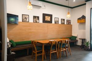 a dining room with a wooden table and chairs at Bali Bay By Urban Haven in Sanur