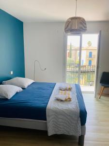 a bedroom with a blue bed with towels on it at Marina with pool in Aigues-Mortes +24 photos