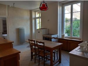 a kitchen with a table and chairs in a room at Gite de Chassigny in Avallon