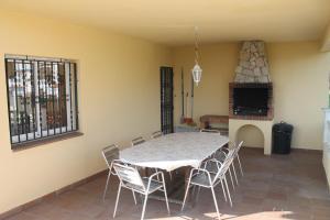 a dining room with a table and chairs at Villa Claudia in Lloret de Mar