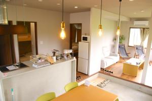 a kitchen and living room with a table and chairs at The Glow Omachi B棟 in Omachi +28 photos