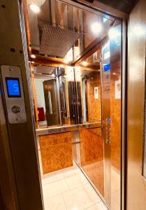 an empty elevator in a room with a glass door at Triton Hotel Piraeus in Piraeus