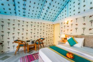 a bedroom with a bed and a table and chairs at Rojani Resort in Sām