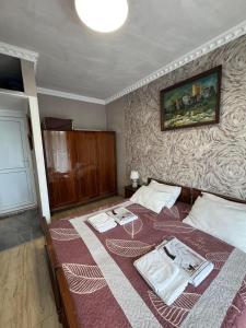 a bedroom with a bed with two towels on it at მყუდრო აპარტამენტი ანაკლიაში, Cozy Apartment in Anaklia in Zugdidi