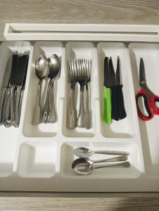 a white tray with silver utensils and scissors at Aaron guest house 1 in Marghera