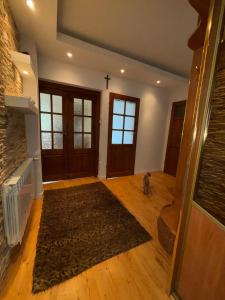 a living room with a fireplace and a cat sitting on a rug at Wypoczynek pod leszczynami in Sitno