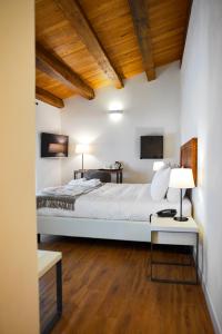 a bedroom with a bed and a table with a lamp at Sopra Le Mura in Castellammare del Golfo