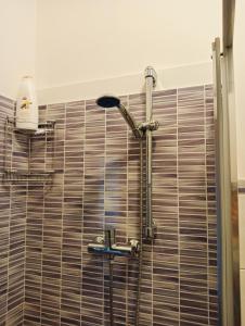 a shower with a faucet in a bathroom at Aaron guest house 1 in Marghera