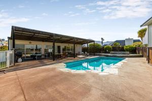 a swimming pool in the backyard of a house at Resort-Style 2BR Alpine Apt | Pool, Spa & Garage in Wanaka
