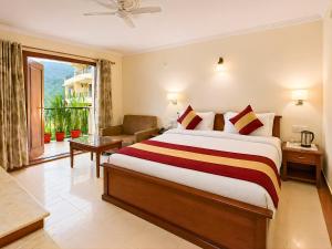 a hotel room with a large bed and a balcony at juSTa Riverside Resort Srinagar in Devaprayāg +83 photos