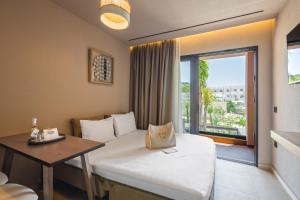 a hotel room with a bed and a window at Palmea Suites in Pefki +74 photos