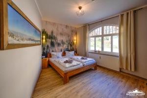 a bedroom with a bed and a large window at Auszeit im Harz Haus 1 Wohnung Feuerstein in Schierke