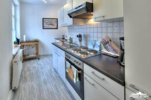 a kitchen with a sink and a stove at Auszeit im Harz Haus 1 Wohnung Feuerstein in Schierke