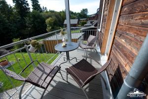 a patio with chairs and a table on a balcony at Auszeit im Harz Haus 1 Wohnung Feuerstein in Schierke