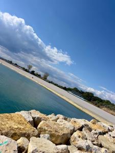 a road next to a body of water with rocks at Condo Blaxy Resort Olimp in Olimp
