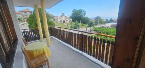 a balcony with a table and chair and a view at Атлас in Byala