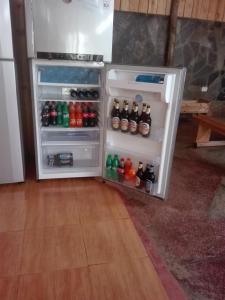 un frigorifero aperto pieno di bottiglie di soda di The Paradise In Kilimanjaro a Moshi