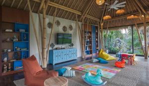 a childrens room with a play area with a tv at Plataran Ubud Hotel & Spa in Ubud