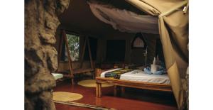 a bedroom with a bed with a canopy at Lake Natron Tented Camp in Mtowabaga +24 photos
