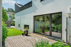 a house with large windows and a patio at Modern House, Pool, Garden in Burgdorf