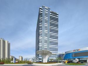 a tall building with a sculpture in front of it at Four Points by Sheraton Rizhao Central Activities Zone in Rizhao