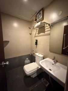 a bathroom with a toilet and a sink at Astra Hotels and Suites HSR Sector 1 in Bangalore +66 photos