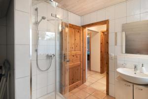 a bathroom with a shower and a sink at Ferienwohnung "Am Hennenberg" in Erlenmoos +20 photos