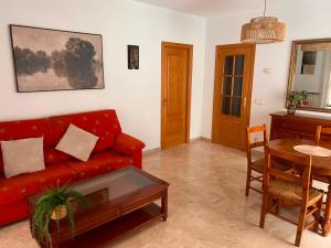a living room with a red couch and a table at Aurora in Teruel