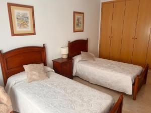 a bedroom with two beds and a cabinet at Aurora in Teruel