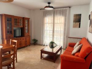 a living room with a red couch and a table at Aurora in Teruel
