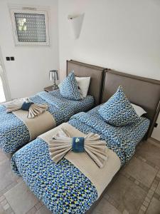 three beds with bows on them in a room at sci marie dominique in Olmeto