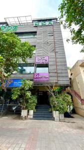 a building with a sign on the front of it at Astra Hotels and Suites HSR Sector 1 in Bangalore